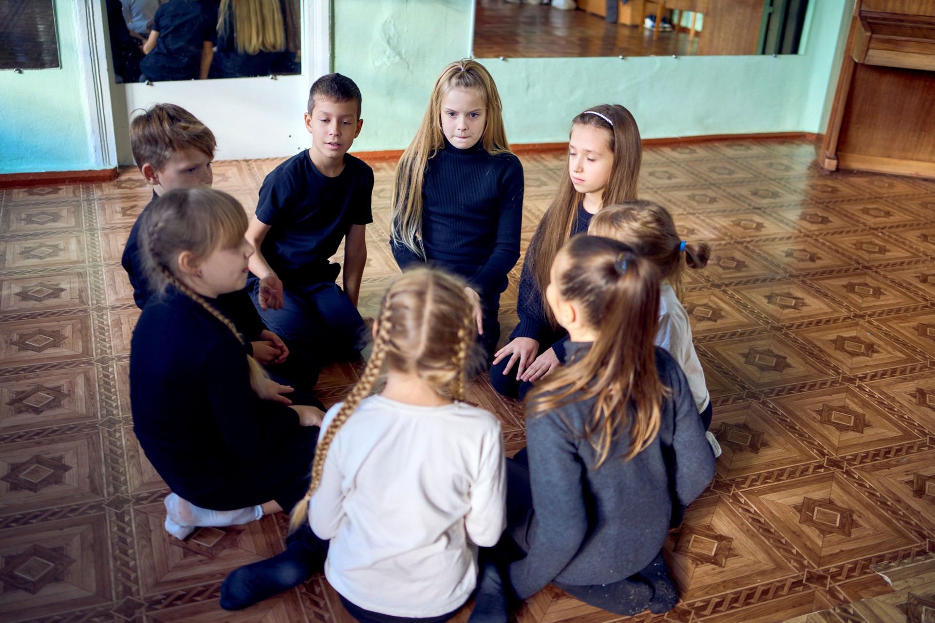 a group of pre-teens perform a teacher's task during an acting class, communication in a circle